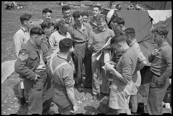 Members of 6 NZ Infantry Brigade Band in Volturno Valley, Italy, receive mail from home - Photograph taken by George Bull