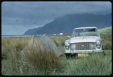 Image: Austin A40 automobile parked beside a small tent, Wairarapa
