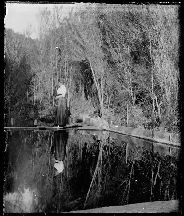 Woman standing on weir
