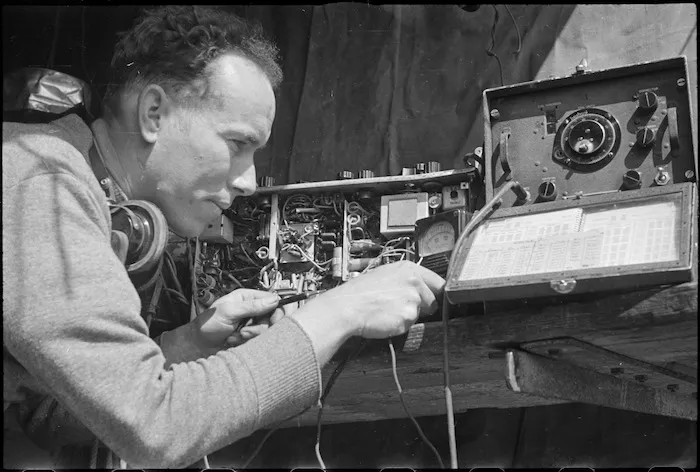 H L Willacy makes final adjustments to a wireless set on the Monte Cassino Front in Italy, World War II - Photograph taken by George Kaye