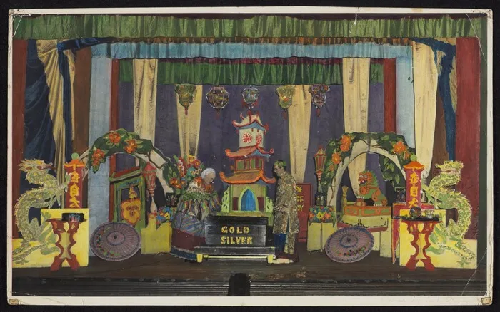 Hand-coloured photographic print of The Great Benyon in performance with Chinese-style dragons and pagodas as stage props. ca 1955]