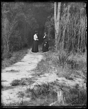 Image: Two women standing on a path among trees