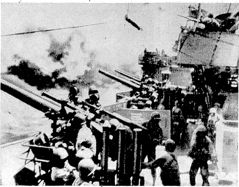 The decks of a United States cruiser as the crew pour shells into one of the Pacific Islands held, by the Japanese. (Evening Post, 25 November 1943)