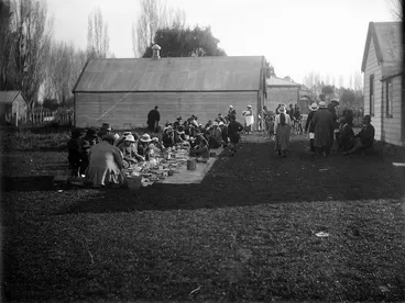 Image: Group of people having a meal at a hui on a unidentified marae