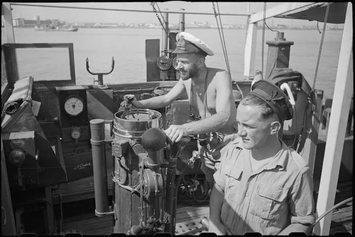 Lieutenant H L Mallitte and Signalman R Geraghty on bridge of World War II minesweeper entering port at Bari, Italy - Photograph taken by George Bull