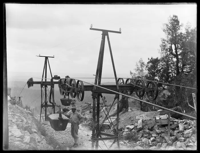Top of aerial tramway, with bucket of ore, and Joseph Divis in foreground