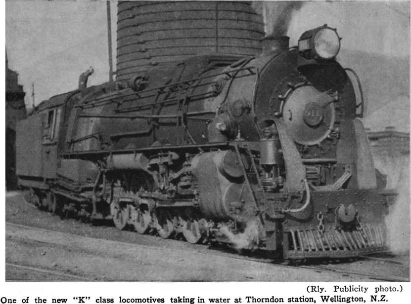 (Rly. Publicity photo.) — One of the new “K” class locomotives taking in water at Thorndon station, Wellington, N.Z