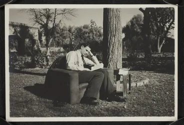 Image: Robert Edward Stout reading in garden in Royal Air Force uniform