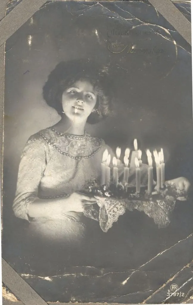 Young woman with birthday cake. c1914-18.