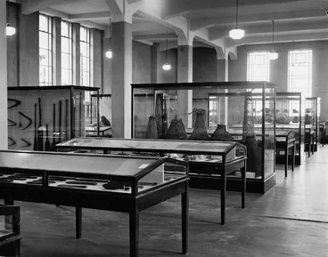 Image: Display cabinets containing Maori artifacts in the Dominion Museum, Wellington