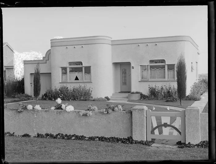 Front view of an Art Deco bungalow and walled garden, location unidentified