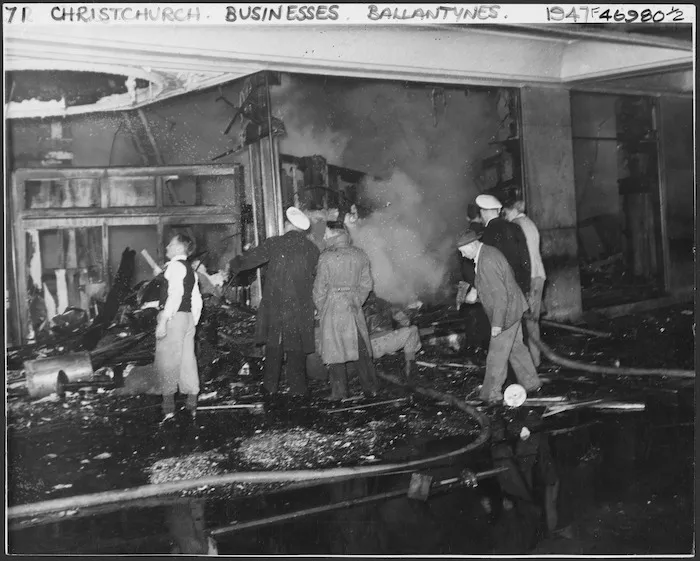 Workers in the burnt wreckage of Ballantyne's department store, trying to make an entrance to the basement