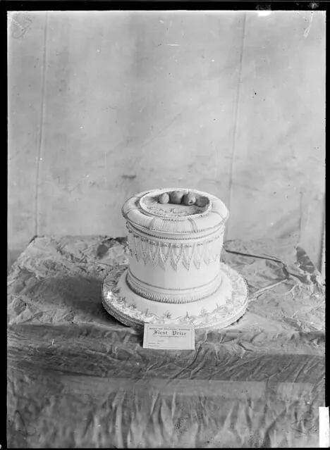 Stall at a trade fair showing the decoration on a cake that won first prize in the New Zealand Bakers' and Pastrycooks' exhibition