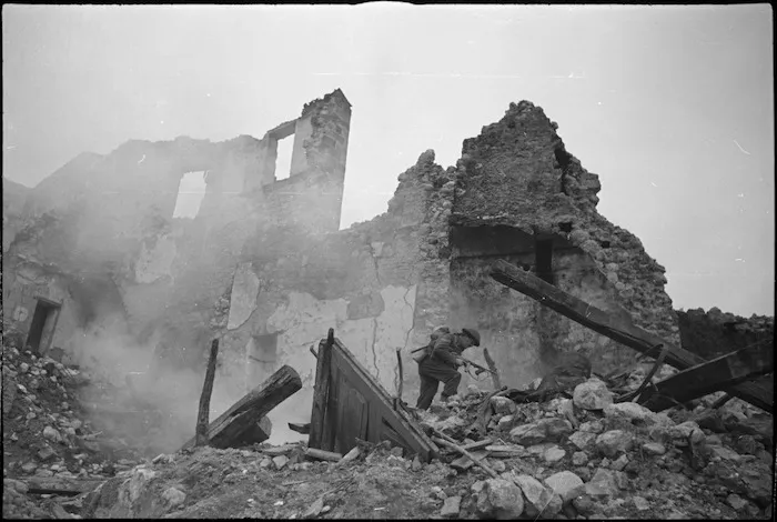 Soldier advancing under cover of smoke screen in NZ Infantry exercise in Italy, World War II - Photograph taken by George Kaye