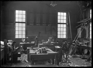 Image: Man reading in a carpenters' workshop