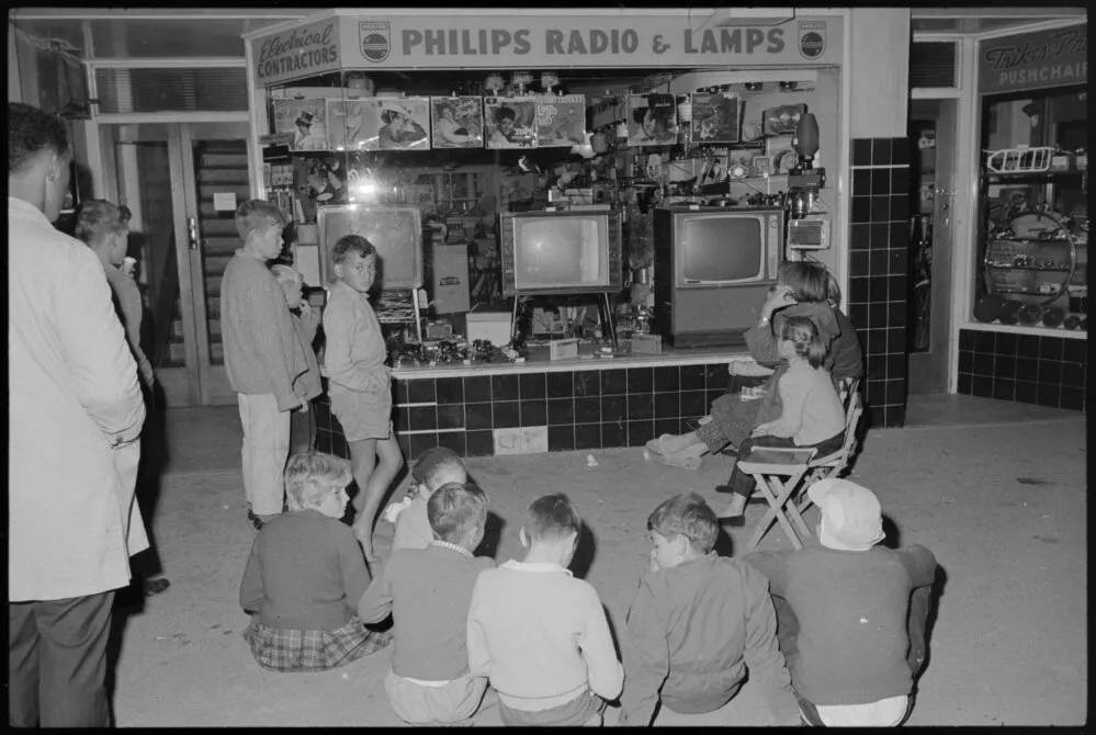 Children watching television at night
