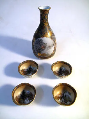 bottle, saki and four cups