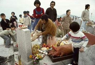 Image: Making offerings at a grave during the spring festival of Ching Ming, Hong Kong