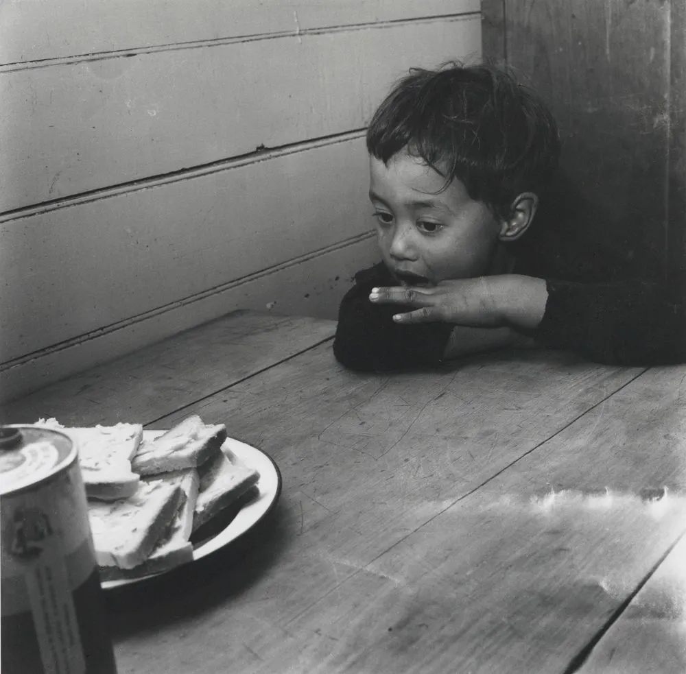 Jimmy can hardly wait for the thick slices of the bread... From the series: Washday at the pa