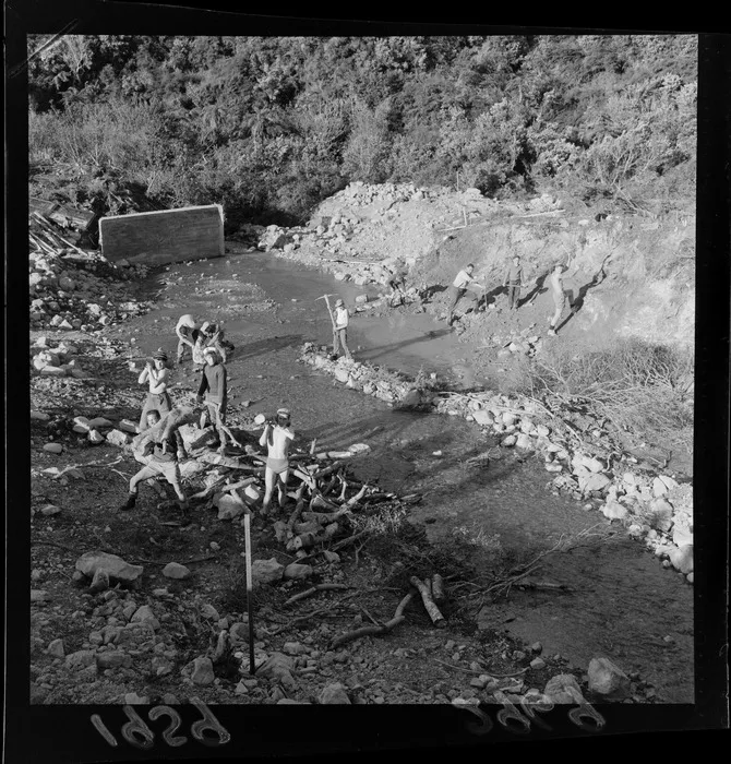 Group of unidentified boys by the river at Boys Brigade camp in Wainuiomata, Wellington.