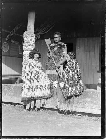 Image: Pura Konui, Mihihi Kuru and Tarihira Mihinui-Northcroft dressed in kakahu and piupiu, at Otūkou marae, Lake Rotoaira