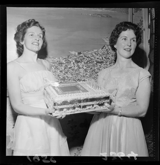 Two unidentified women holding the 21st birthday cake for Jaycee at Skyline [Blue Domino?]