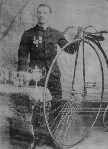 John Edmond Hood, Watchmaker and Jeweller, with Penny Farthing and Cups. Image: John Edmond Hood, Watchmaker and Jeweller, with Penny Farthing and Cups.