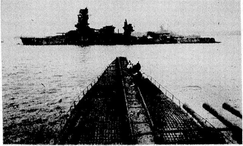 The catapult runway shgwn in the foreground runs. from the "tube" housing the planes to the bow of a big Japanese submarine taken over by the United States navy at Tokio after the surrender of the enemy. This submarine, in "I" glhss, ;is nearly 400 ft long, about 40ft ivide, and of over 3000 tons displacement. It carries three small aircraft, and is larger than any American or . French submarine. The Â•wrecked Japanese battleship Nagato is seen in the background. (Evening Post, 11 October 1945)