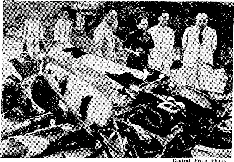 Madame Chiang Kai-shek, wife of the Chinese generalissimo, inspecting the wreckage of a Japanese bomber shot down in the Canton area. (Evening Post, 26 September 1938)