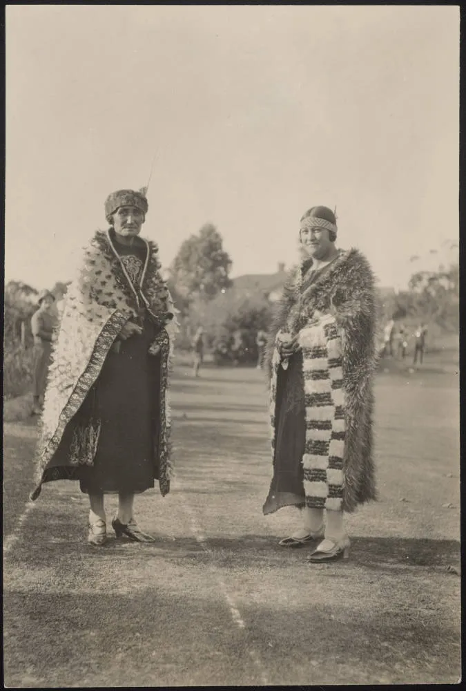 Two women wearing kahu huruhuru