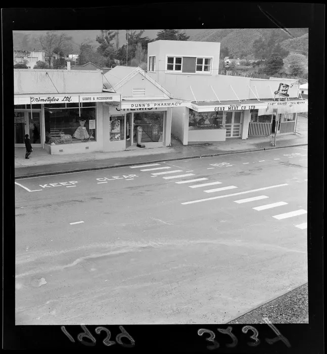 Shops at Wainuiomata, Lower Hutt City, Wellington Region, including Trimstyles Ltd gowns and accessories, Dunns Pharmacy, Gear Meat Company Ltd, and Top Hat dairy and tearooms