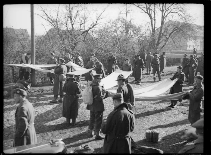 Allied prisoners of war holding white strips of material - Photograph taken by Lee Hill