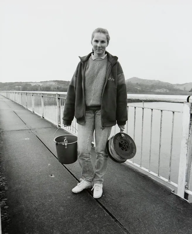 Shiree Blyde, Environment Waikato technician, taking water samples at the Tainui Bridge, Huntly