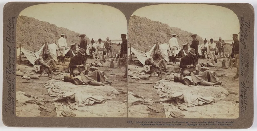 Columbia's noble soldier boys, as kind hearted as brave, American giving water to wounded Japanese after Battle of Tientain, China