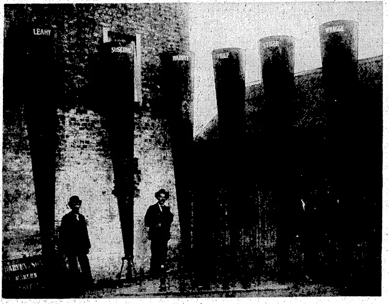 RAINMAKERS.—When the late Mr. Clement Wragge (on,right) was a leading authority on weather topicsnn Australia he had a scheme for overcoming the droughts which so often assailed various'parts of the country. With these huge tubes he bombarded the skies in the hope of making the rain fall. Each lube was named after a prominent climatologist. (Evening Post, 15 October 1936)