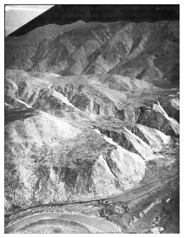 Image: Fig. 6: Marine rock platforms on the spur between the Orongorongo and Wainuiomata Rivers. The Holocene bench is at the bottom right corner. The lowest high level bench is considered to represent the Last Interglacial and to be about 100,000 years old. ...