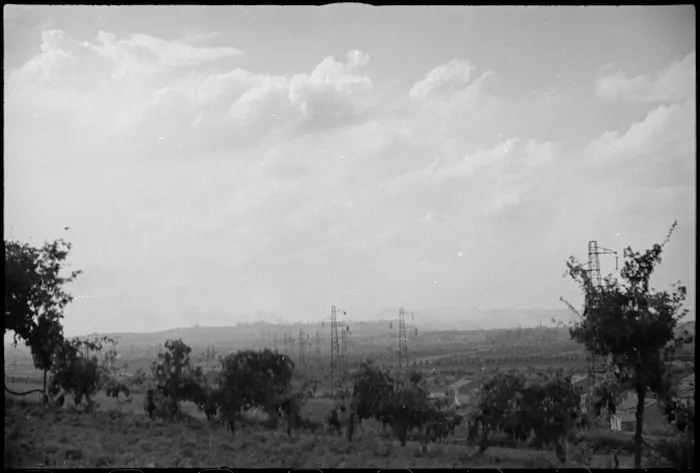 Smoke rising from Rimini, Italy, being heavily bombarded in World War II - Photograph taken by George Kaye