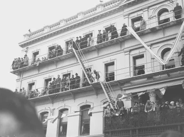 Image: Crowd Watching Victory over Europe ( VE ) Day Celebrations. From the Balcony and Fire Escapes Of Warner's Hotel, Cathedral Square, Christchurch, Canterbury, New Zealand.