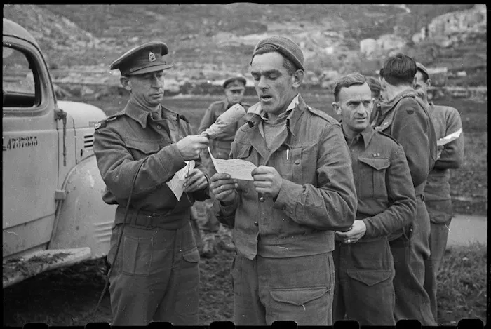 Signalman W Smith recording a message to be broadcast to New Zealand on the Cassino Front, Italy - Photograph taken by George Bull