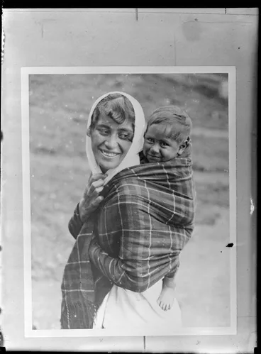 Image: Annie Ngauru Hoko (nee Downs) woman carrying a young child on her back wrapped in a blanket