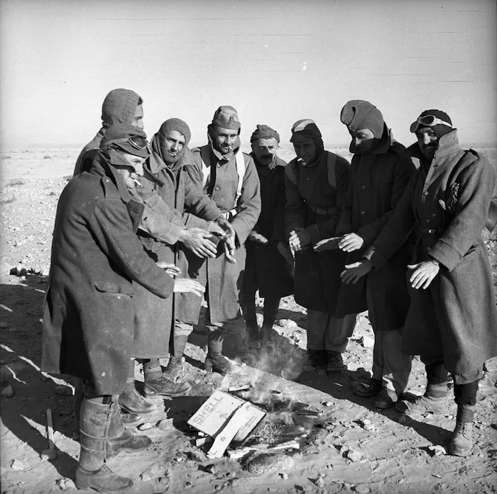 World War II New Zealand soldiers warming their hands by a fire, Western Desert, Egypt