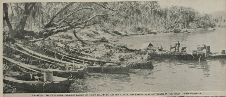 American troops examine Japanese barges on Seleo Island, Dutch New Guinea