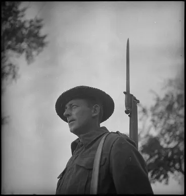 Image: NZ Infantryman A F Sedgwick on guard outside battle HQ in Sangro River area, Italy, World War II - Photograph taken by George Kaye