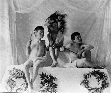 Three boys holding white lilies
