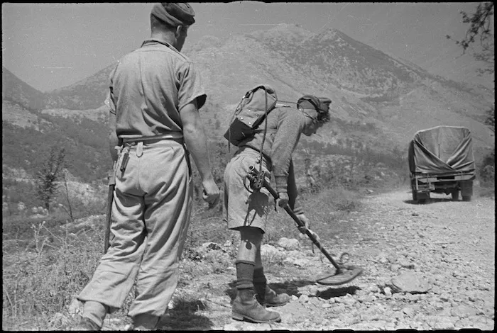 F G Smith and T Turner sweeping road edge for hidden mines in Belmonte area, Italy, World War II - Photograph taken by George Kaye