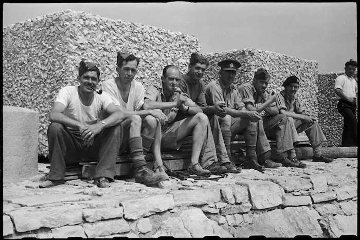 New Zealanders enjoying sun on the breakwater near 1 NZ Convalescent Depot at Santo Spirito, Italy, World War II - Photograph taken by George Bull