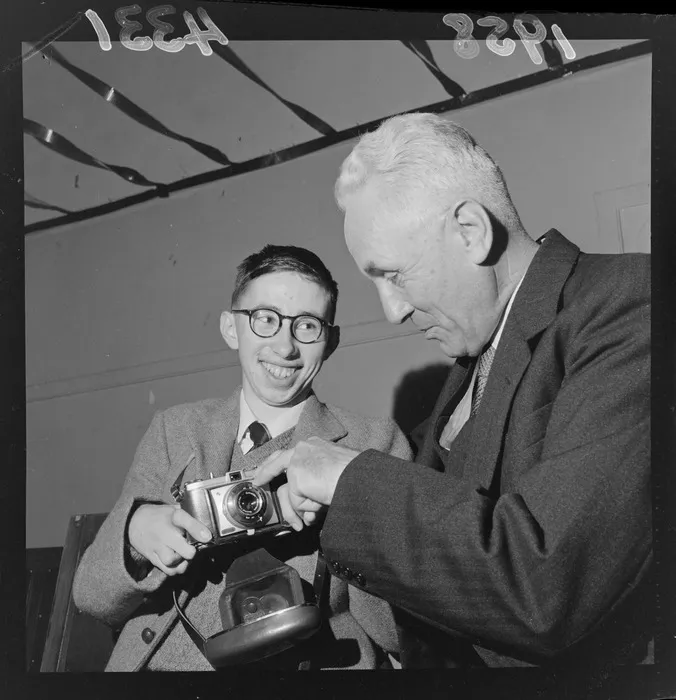 Geoffrey Sanderson from The Correspondence School in Wellington, inspects an unidentified student's camera