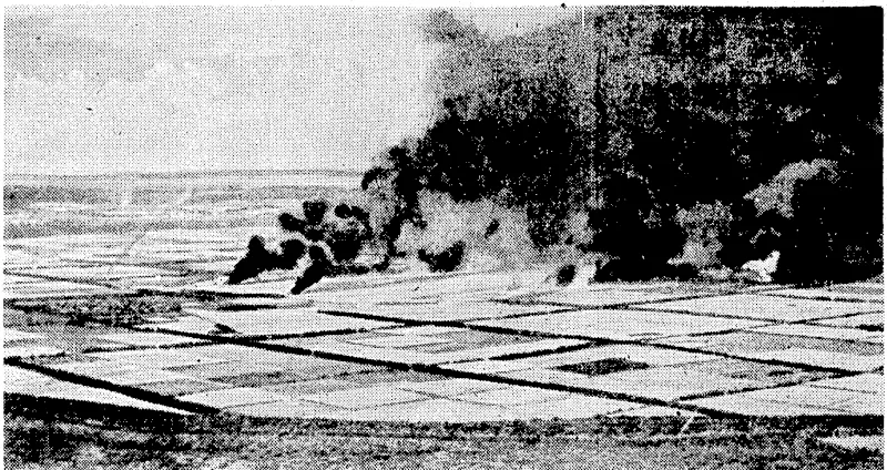 Offlci.il U.S. Navy Photo. Japanese planes burning on the airstrip at Tinian Island, a Japanese stronghold in the Marianas, following an attack on February 23 by United States Navy carrier-based planes. (Evening Post, 29 March 1944)