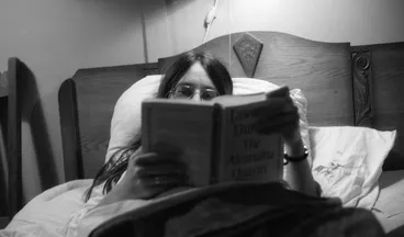 Image: Simone in bed with book