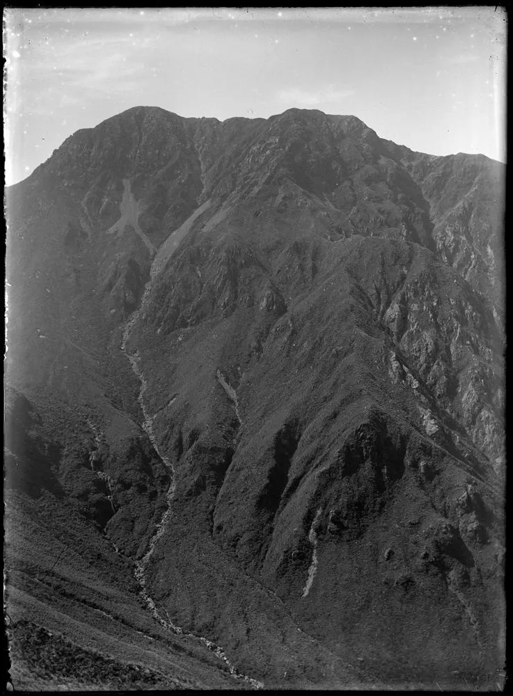 2000 feet of precipices -- the south-west face of The Mitre Peak, 5154ft, the highest summit of the Tararuas. Head of Bennington Creek at the foot